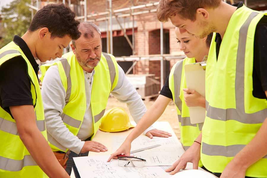 construction workers looking at plans