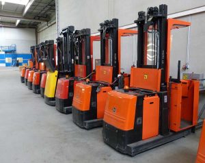 row of forklifts in warehouse